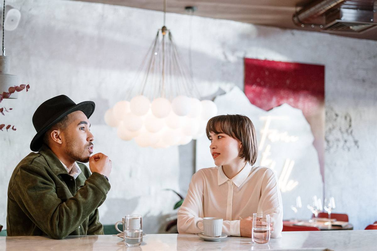 Two people in conversation across a table